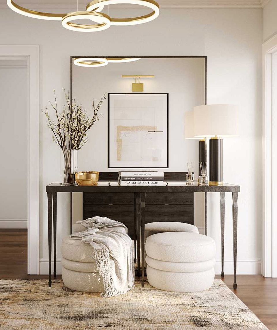 Sophisticated entryway with dark console, cream poufs, and minimalist modern fixtures