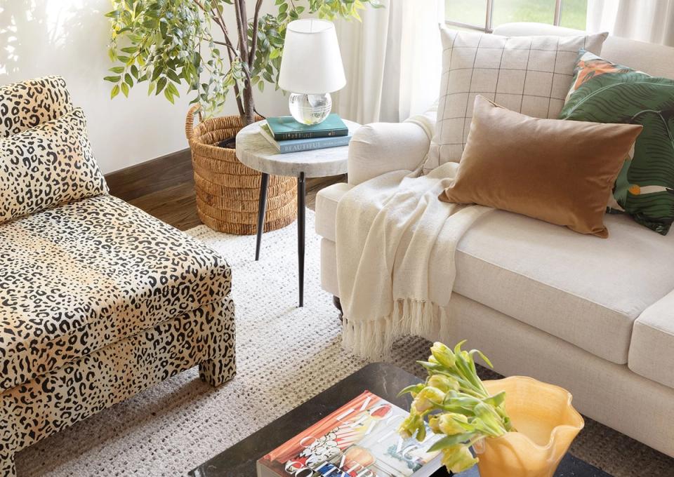 Bright living room blending animal print, geometric patterns, and earth tones with cream upholstery and natural textures