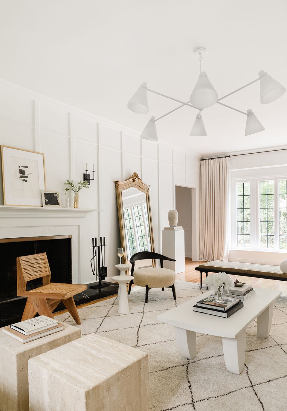 Scandinavian living room with warm wood accents, pendant lights, and neutral palette creating airy, minimalist ambiance.