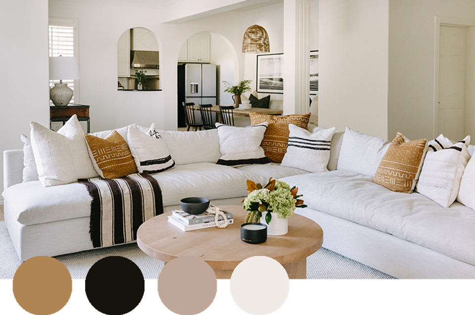 Bright coastal living room in cream and white with warm wood accents and striped details