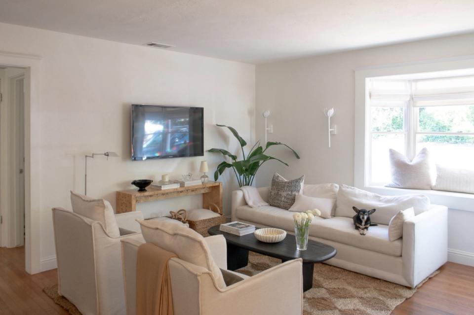 Airy transitional living room with cream furnishings, natural light, and warm wood accents