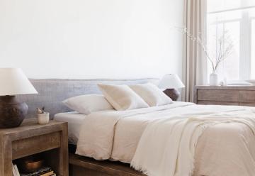 Calming bedroom with gray upholstered headboard and warm neutral bedding