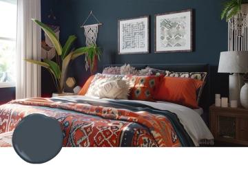 Eclectic bedroom featuring deep navy walls, vibrant rust and burnt orange bedding, botanical elements, and boho touches