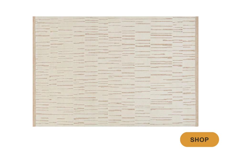 Neutral woven area rug with subtle linear texture in cream and tan palette