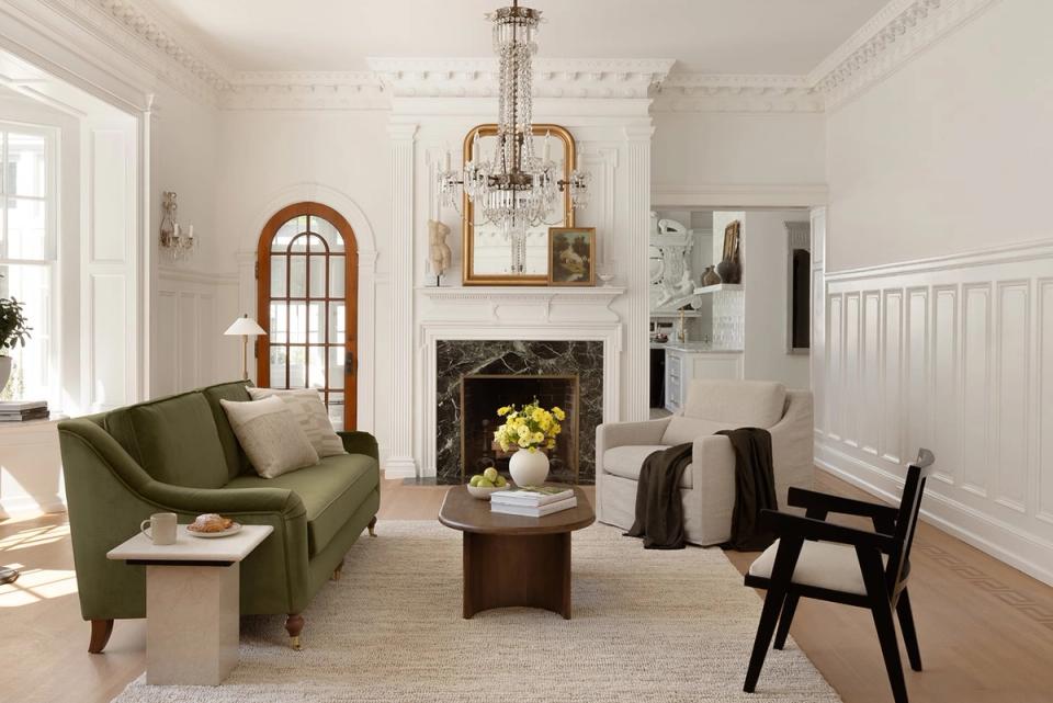 Classic cream living room with olive velvet seating, fireplace, and architectural detailing