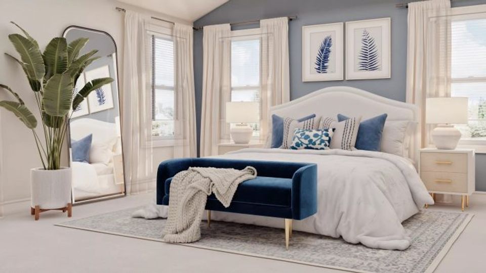 Serene coastal bedroom with soft blue walls, cream bedding, and natural light