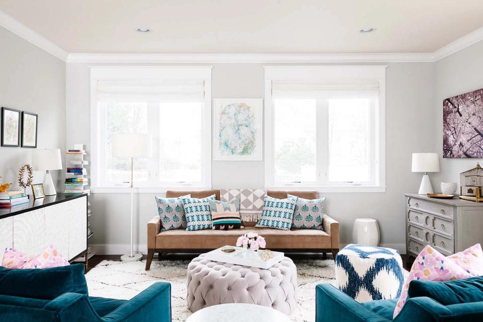 Serene kid's bedroom with teal velvet seating, tan leather sofa, and soft neutral palette