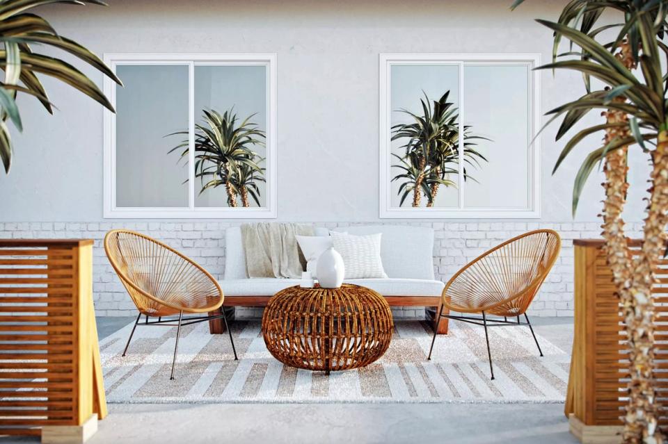 Tropical-inspired patio with woven rattan chairs, palm plants, and coastal charm