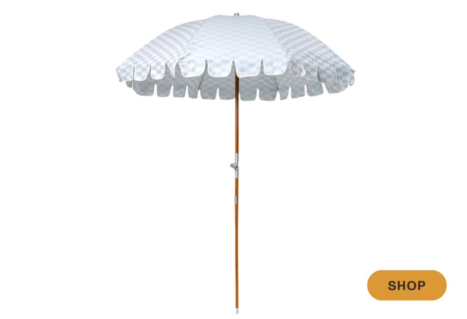 Vintage-inspired beach umbrella with blue and white striped checkerboard canopy