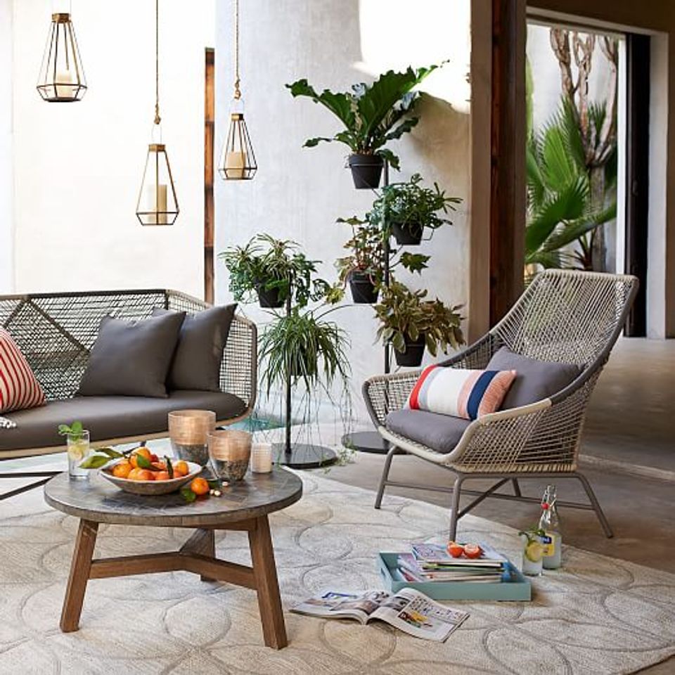 Contemporary coastal patio, rattan chairs, nautical textiles, hanging lights