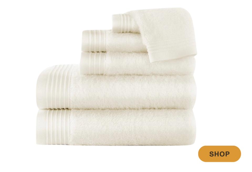 Cream-colored towels with vertical pleated texture, warm minimalist luxury design