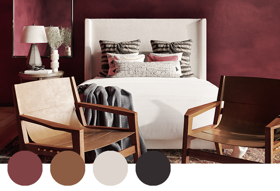 Warm mid-century bedroom with deep burgundy walls, cream upholstered headboard, and wooden accent chairs in rich brown and cream tones