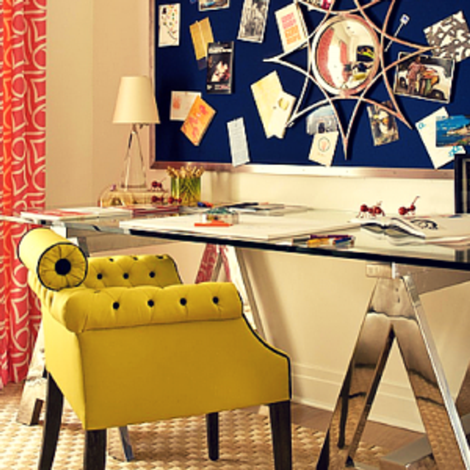 Creative workspace with mustard tufted chair, navy inspiration board, and patterned accents