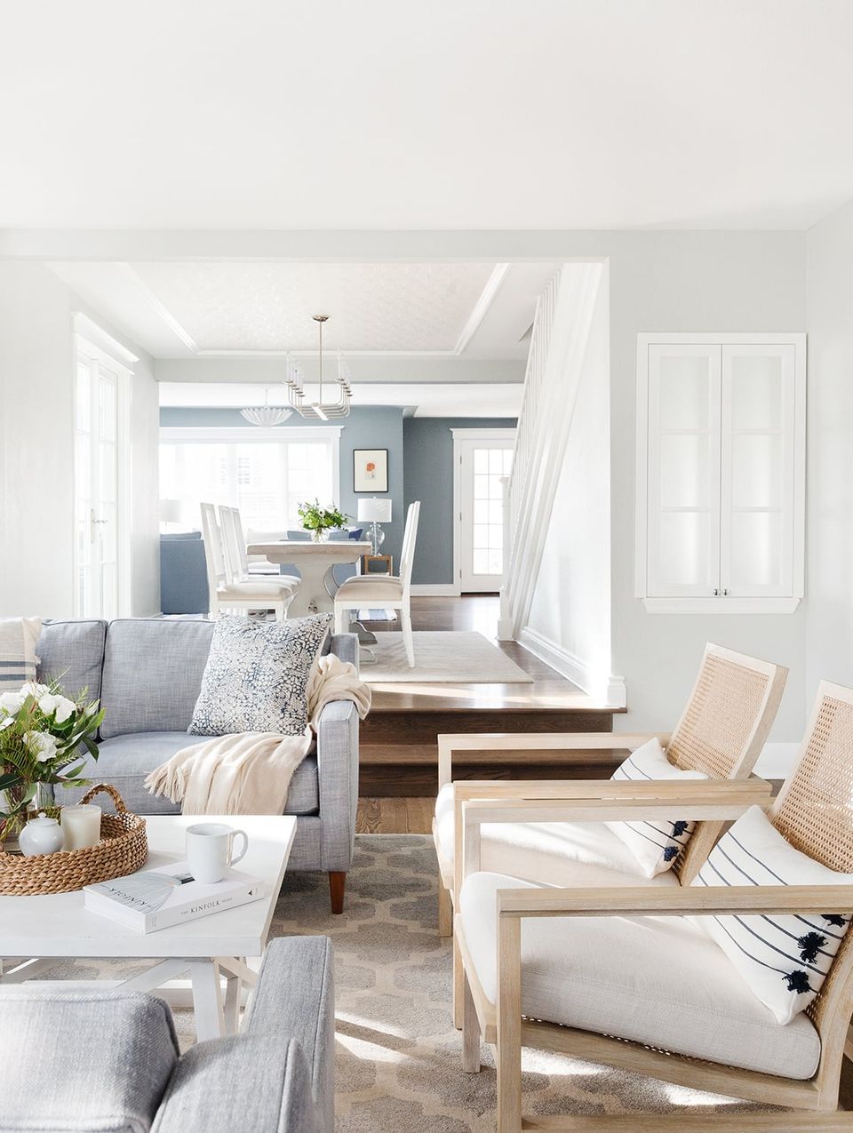 Scandinavian-inspired neutral space with light wood furnishings, soft cream tones, and clean architectural lines