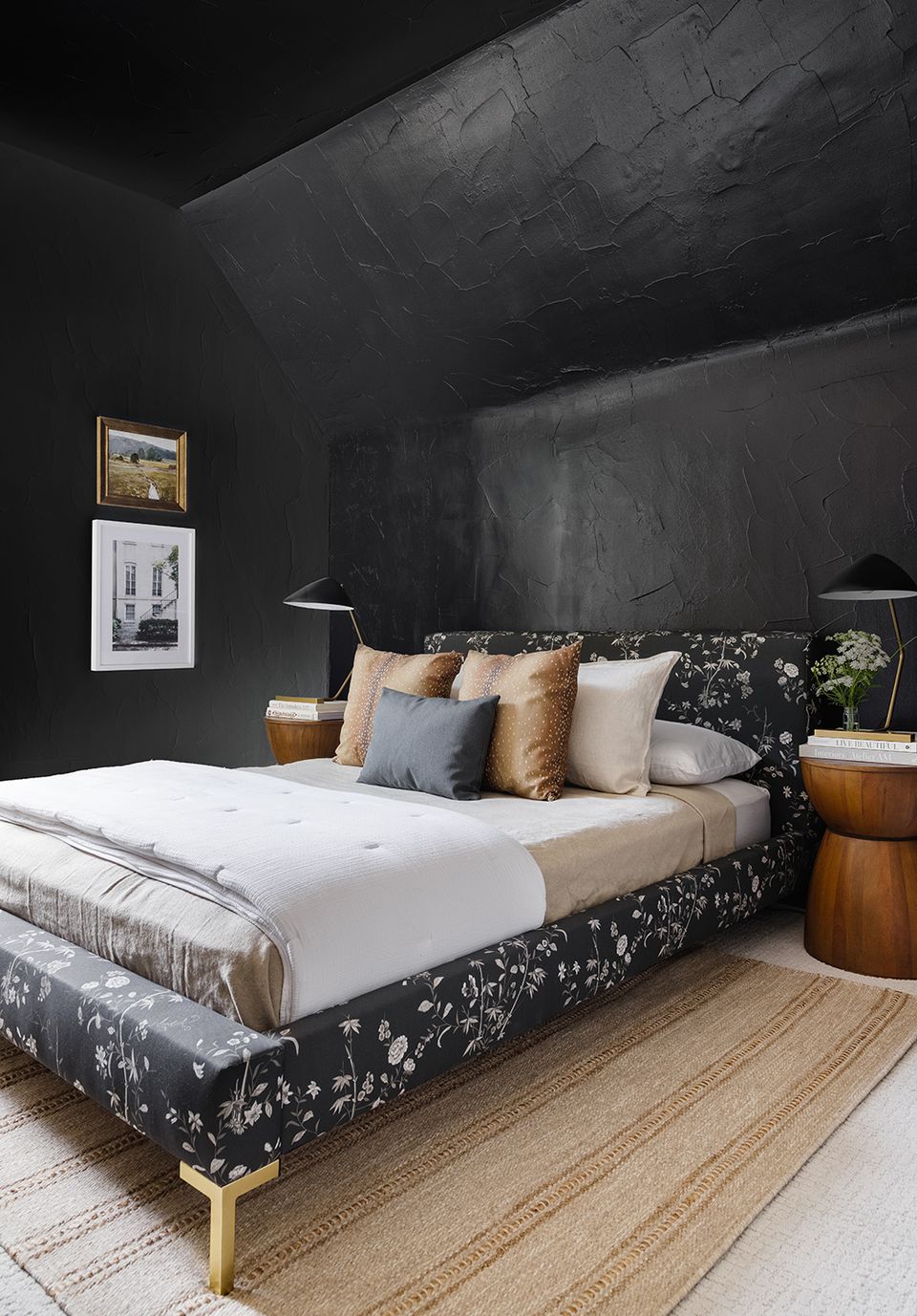 Dramatic moody bedroom with charcoal walls, patterned upholstered bed, and warm wood nightstands