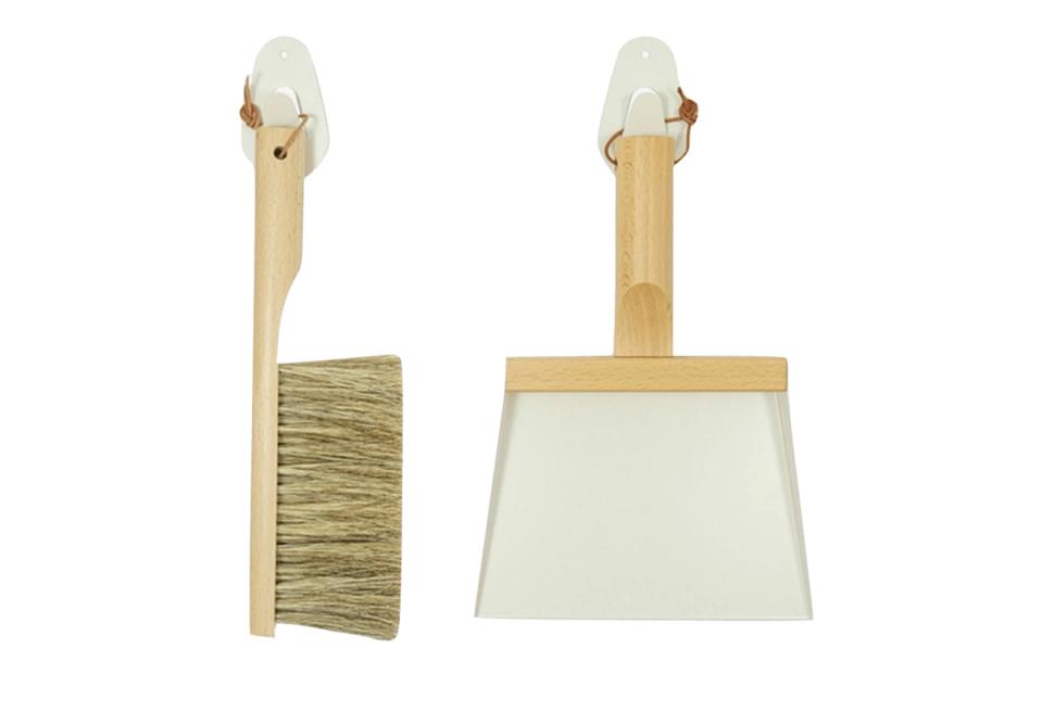 Minimalist natural wood cleaning tools with white ceramic heads in scandinavian style