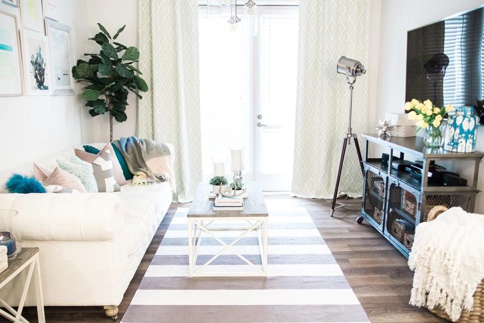 Bright scandinavian living room with cream curtains, natural light, and airy minimalist furnishings