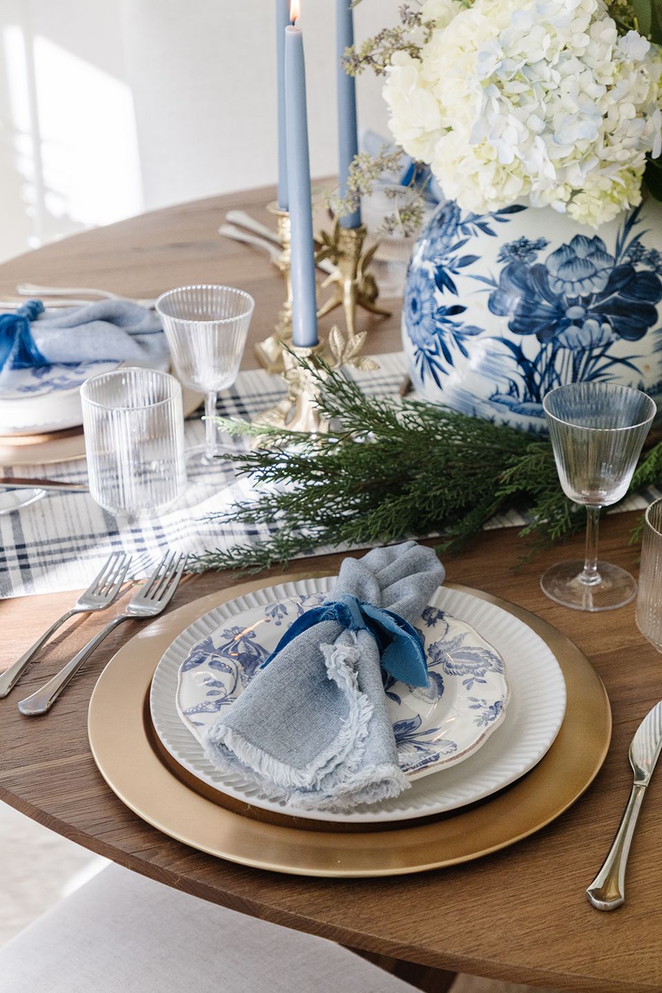 Serene blue and white coastal-inspired tablescape with natural greenery and soft linen accents