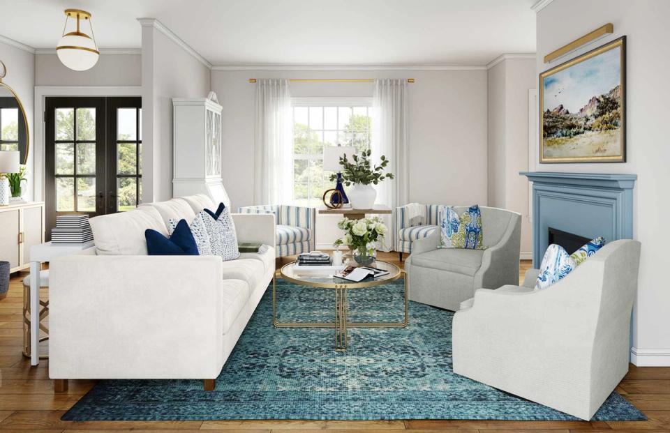 Bright New England living room with navy accents, white furnishings, and teal rug