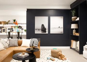 Modern living room with diptych minimalist art on deep navy wall and warm leather furniture