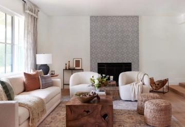 Contemporary living room with cream swivel chairs, rust accent pillows, and minimalist modern aesthetic.