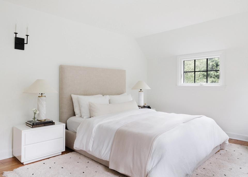Contemporary minimalist bedroom in soft beige and white with peaceful, uncluttered aesthetic