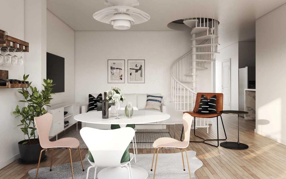 Scandinavian dining room with minimalist white round table, light wood accents, soft pink chair, and bright airy palette creating serene modern aesthetic