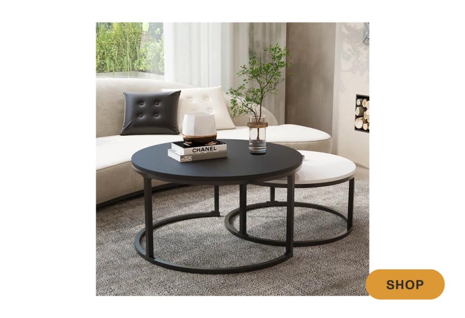Contemporary round black coffee table in modern living space with neutral tones