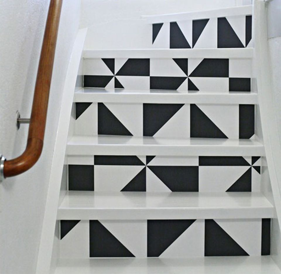 Modern geometric staircase with bold black and white triangular peel-and-stick wallpaper pattern