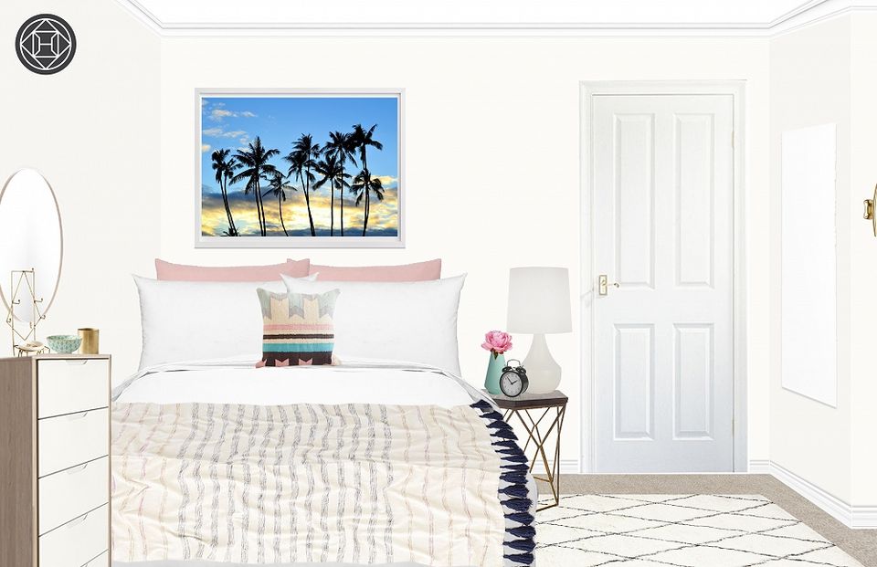 Serene coastal bedroom with palm artwork, cream linens, and soft pink nightstand styling