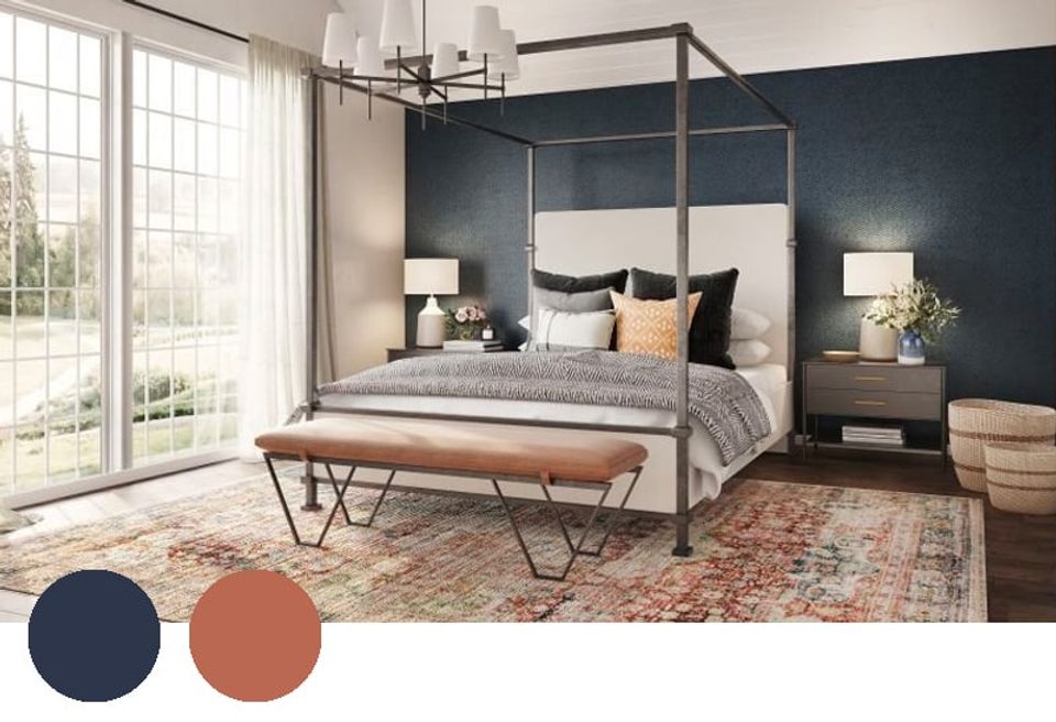Contemporary bedroom with navy accent wall, warm terracotta tones, metal frame bed, and balanced neutral palette.