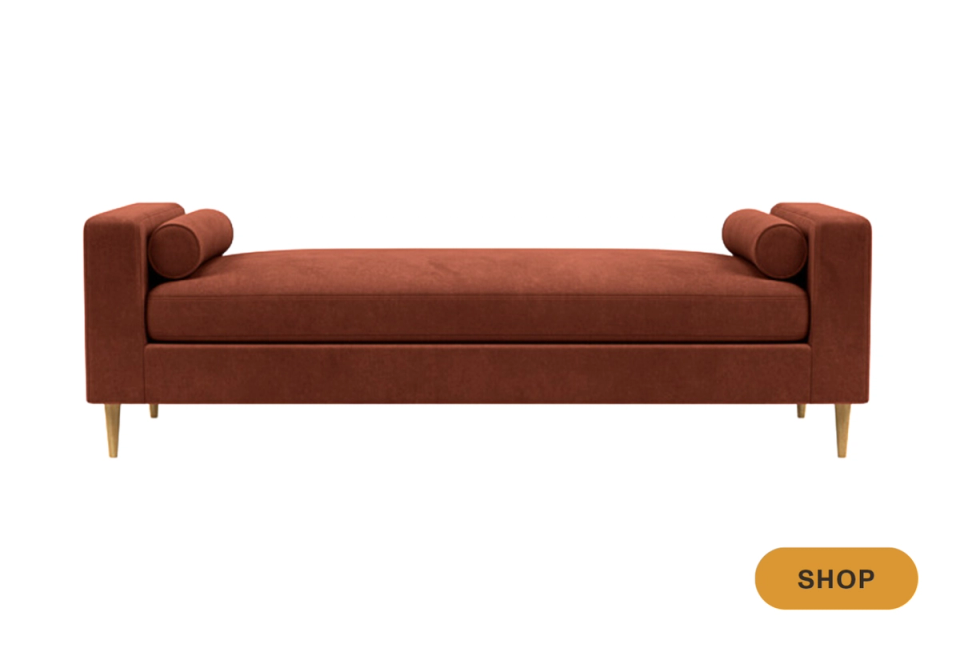 Sophisticated rust-toned upholstered daybed with tapered wooden legs and modern arm design.