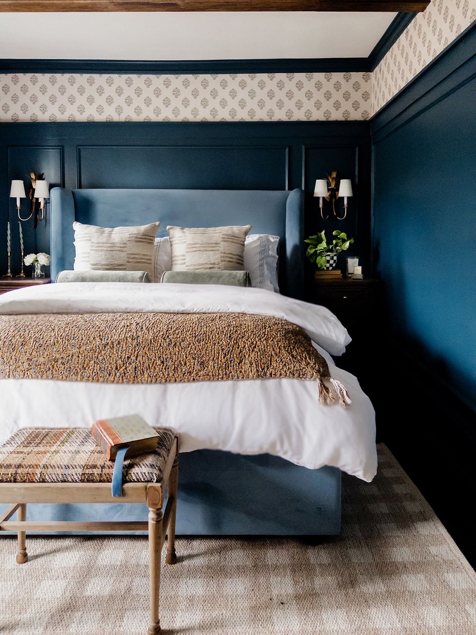 Deep teal contemporary bedroom with natural textures, neutral bedding, and sconce lighting