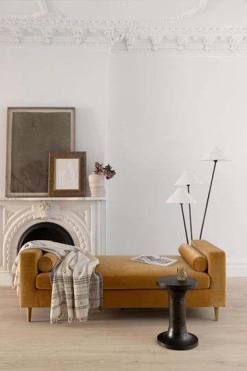 Minimalist entryway with caramel leather bench and ornate fireplace mantel