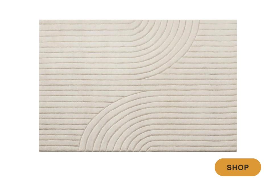 Contemporary minimalist rug with organic curved line pattern in cream and white