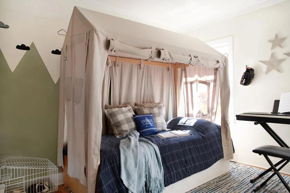 Soft, whimsical bedroom with linen canopy bed, sage green accent wall, muted nautical textiles, and airy natural light emphasizing calm, dreamy aesthetic.