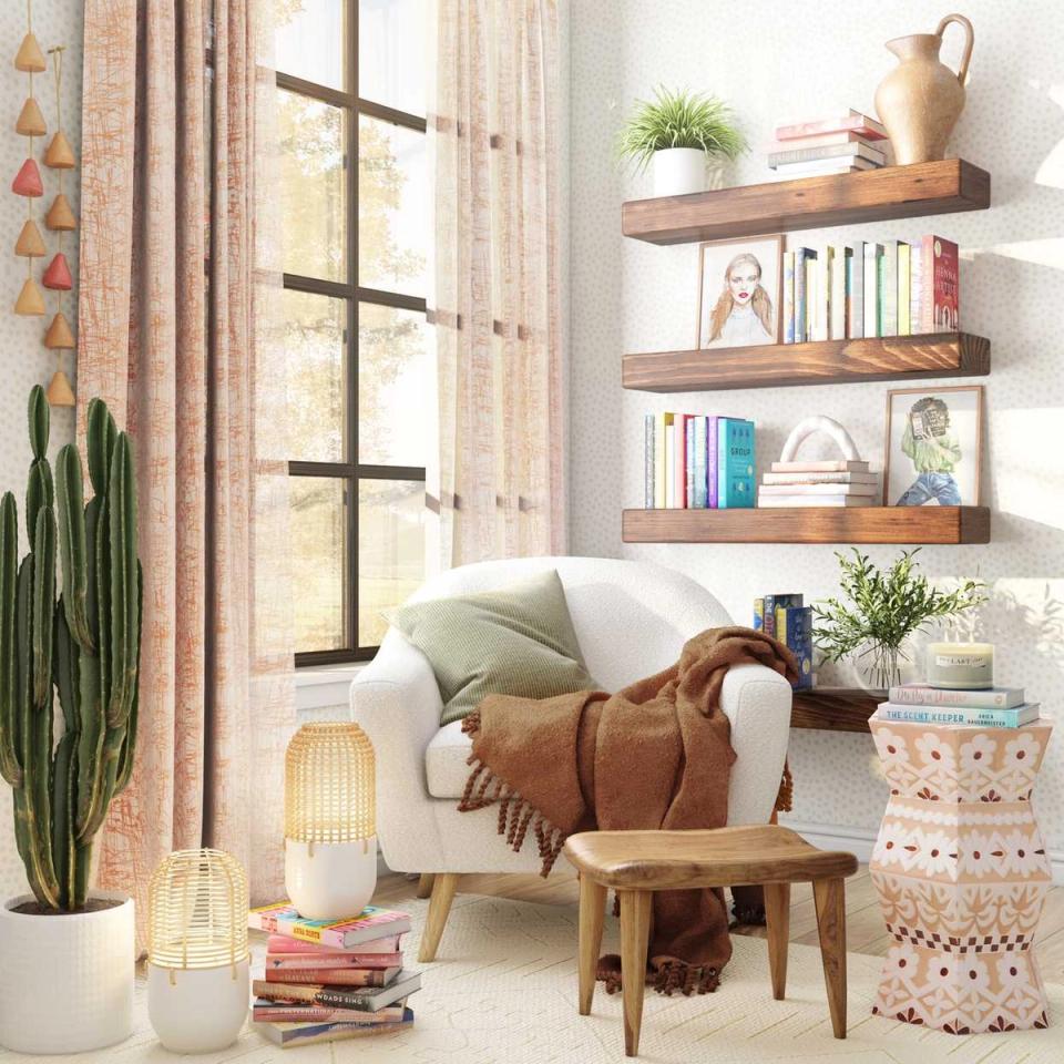 Warm boho reading nook with cream armchair, wooden shelves, terracotta accents, and natural light