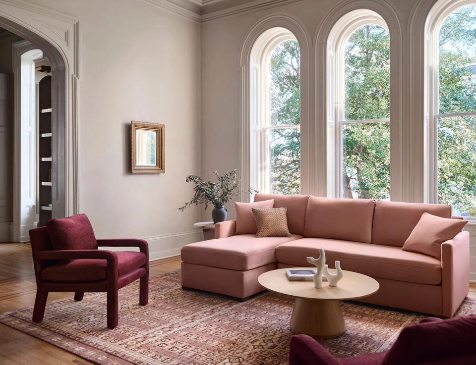 Refined living room in mauve and dusty rose with arched windows and neutral luxury aesthetic
