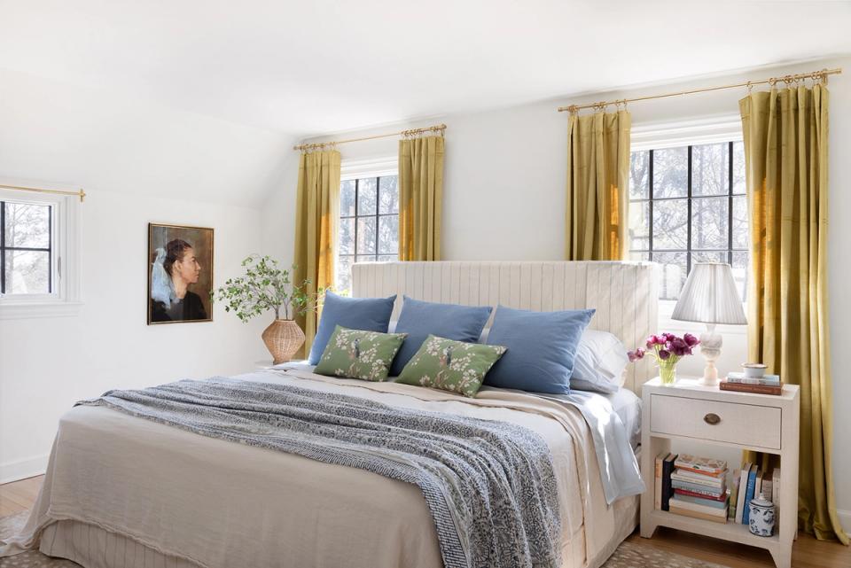 Bright modern bedroom with white shiplap, golden curtains, and blue-green accents balancing calm sophistication