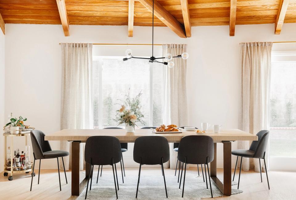 Scandinavian dining room with exposed wooden beams, neutral palette, and natural light