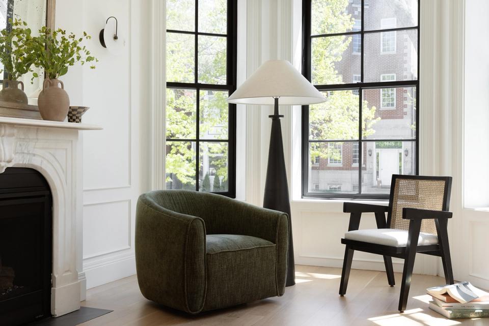 Mid-century modern living room with olive curved chair and black wood seating