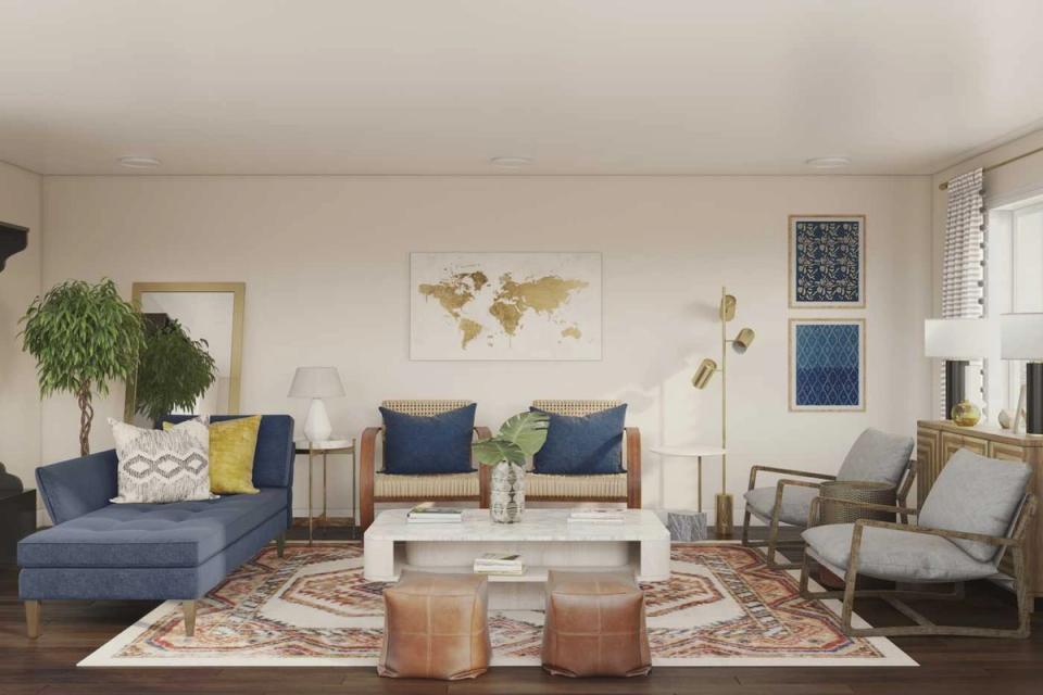 Boho living room with blue upholstered seating, warm terracotta accents, layered geometric rugs, and natural wood elements creating a relaxed, earthy aesthetic.