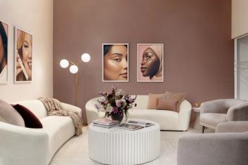 Modern living room with warm mauve accent wall, cream curved furniture, and contemporary portrait gallery creating a sophisticated, neutral palette.