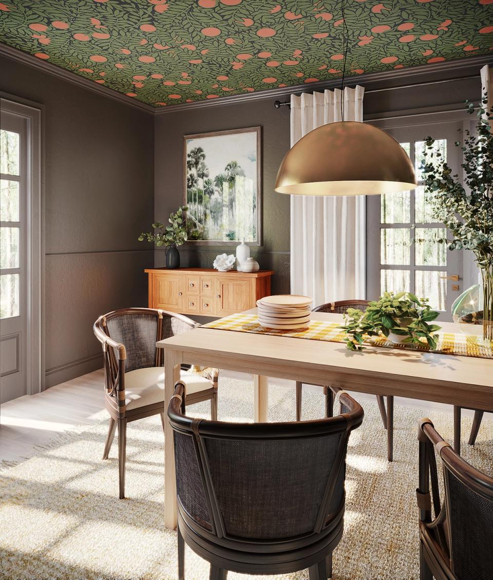 Eclectic dining room with floral ceiling wallpaper, dark walls, and mixed vintage wood furniture