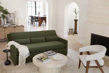 Scandinavian living room with forest green sofa, light wood furniture, and cream accents creating warm, cohesive mixed-wood aesthetic