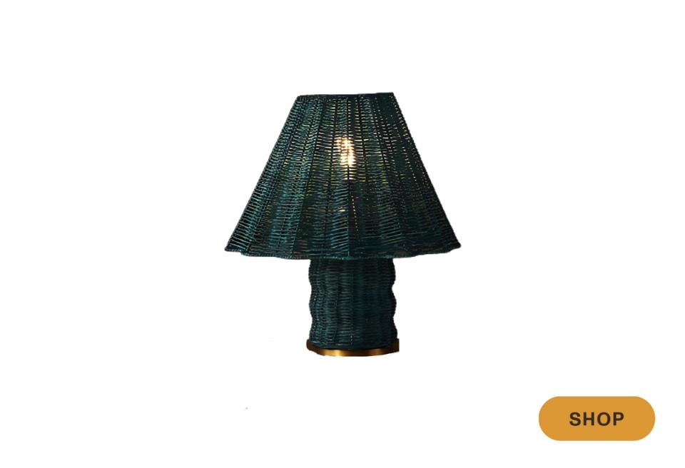 Rich forest green pleated shade on textured base, moody sophisticated lighting