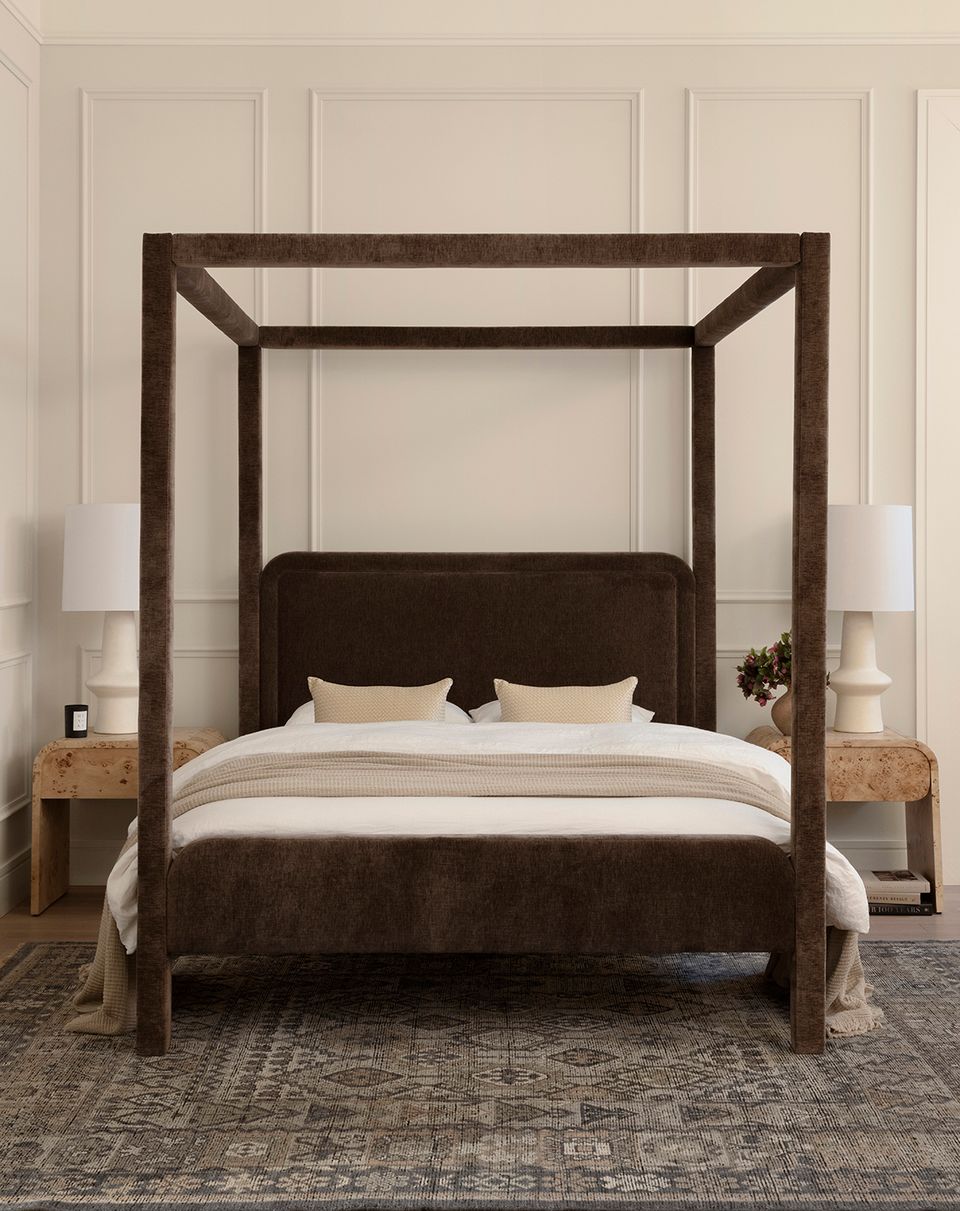 Organic modern bedroom with dark wood four-poster canopy bed, cream bedding, warm neutral palette, and natural textures throughout