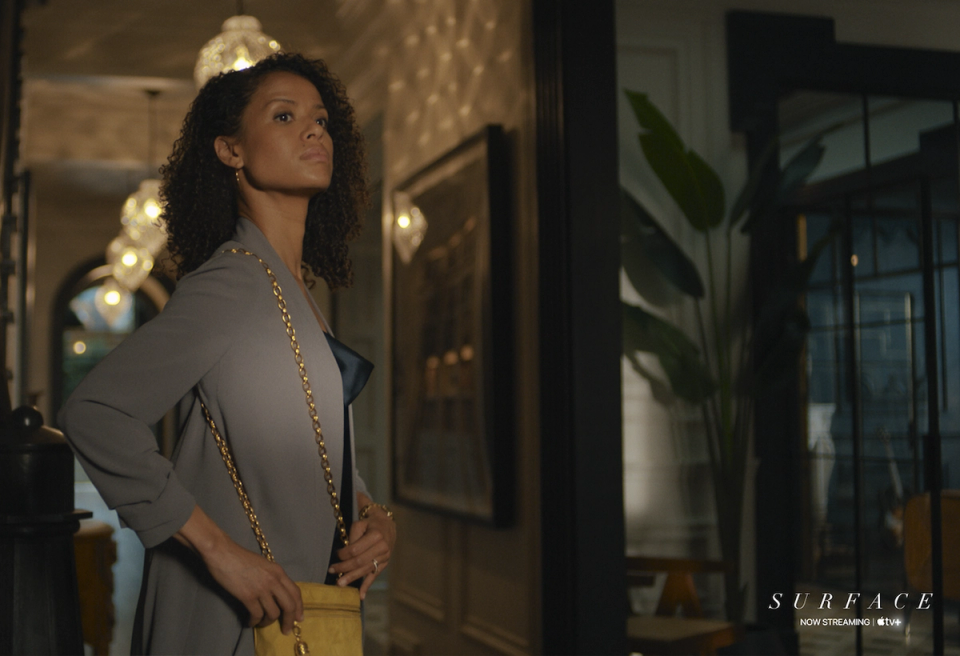 Luxe contemporary hallway with warm golden lighting, modern art, and sophisticated neutral palette