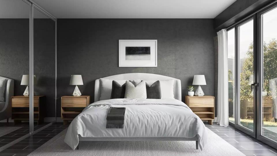 Contemporary dark bedroom with soft gray walls, white linens, and minimalist mid-century nightstands