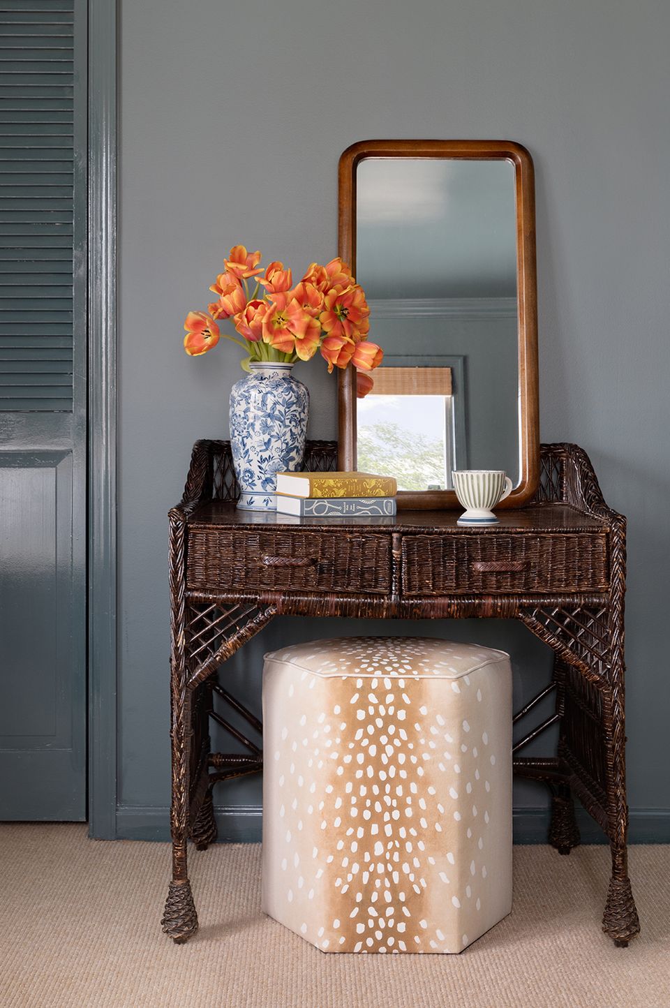 Sophisticated gray entryway with warm wood console and orange floral accent